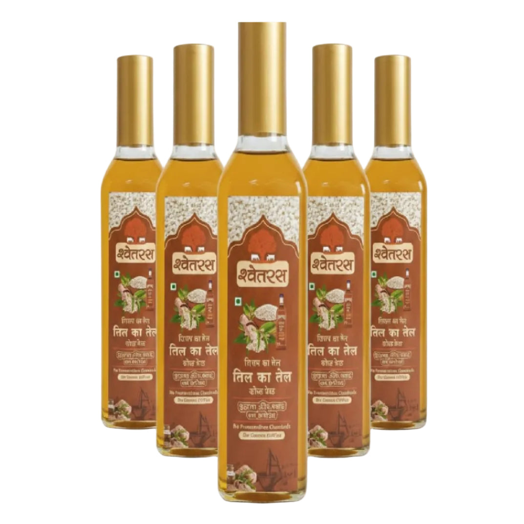 Five bottles of Shwetras oil with gold caps on a white background