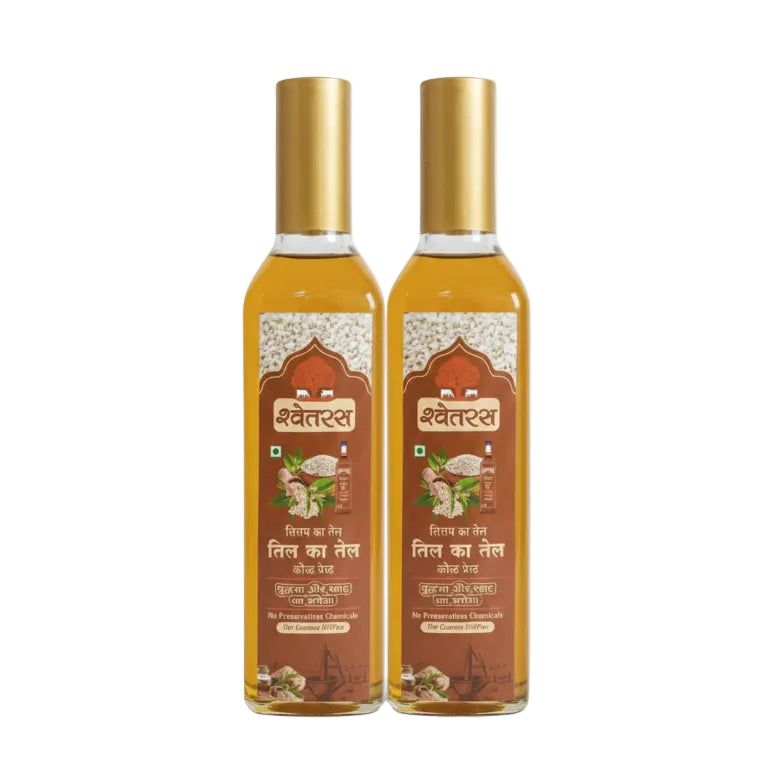 Two bottles of Shwetras oil with gold caps on a white background