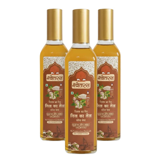 Three bottles of Shwetras oil with gold caps on a white background